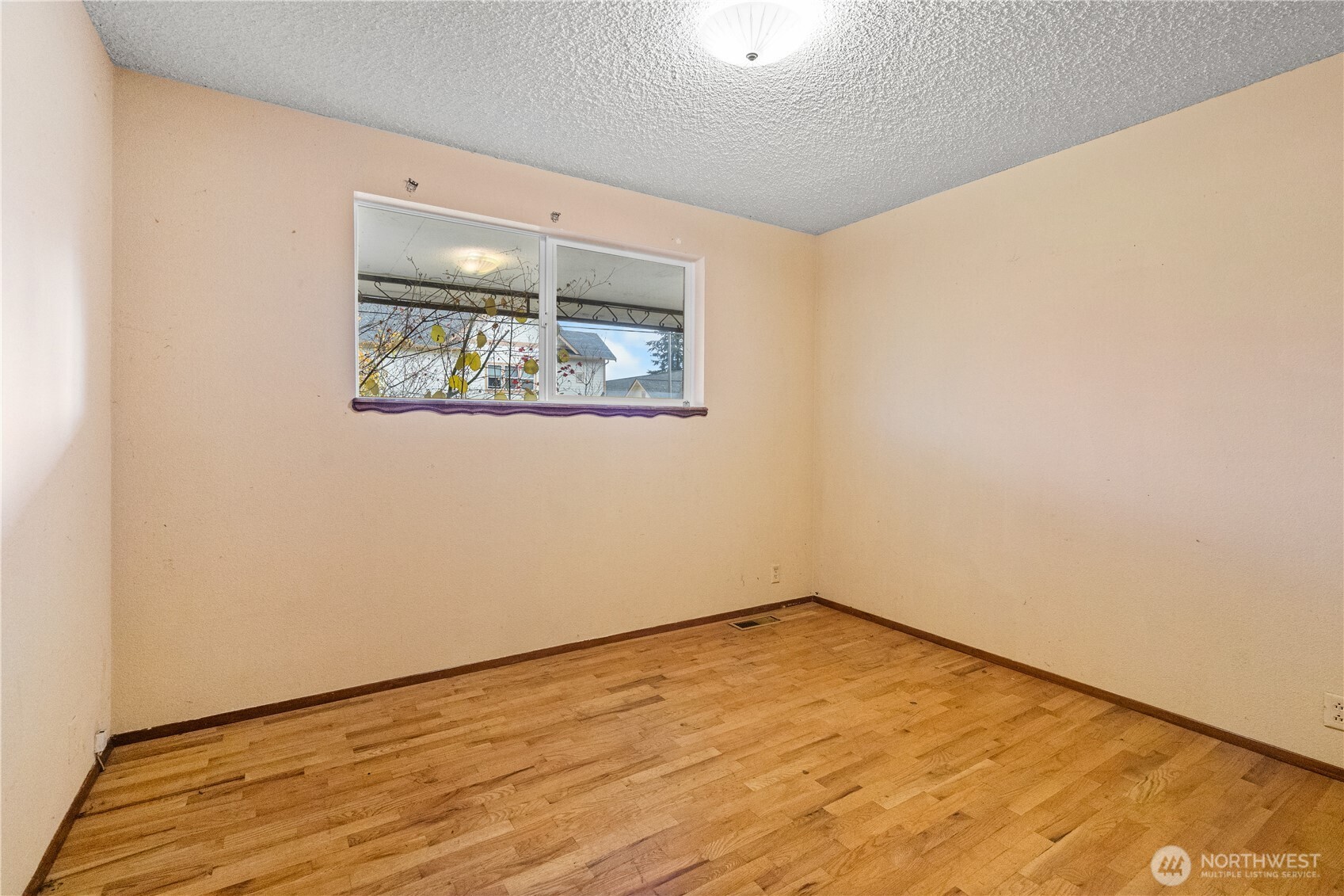 9139 Burnett Road Southeast Yelm, WA 98597 - Photo 20 of 40 an empty room with wooden floor and window
