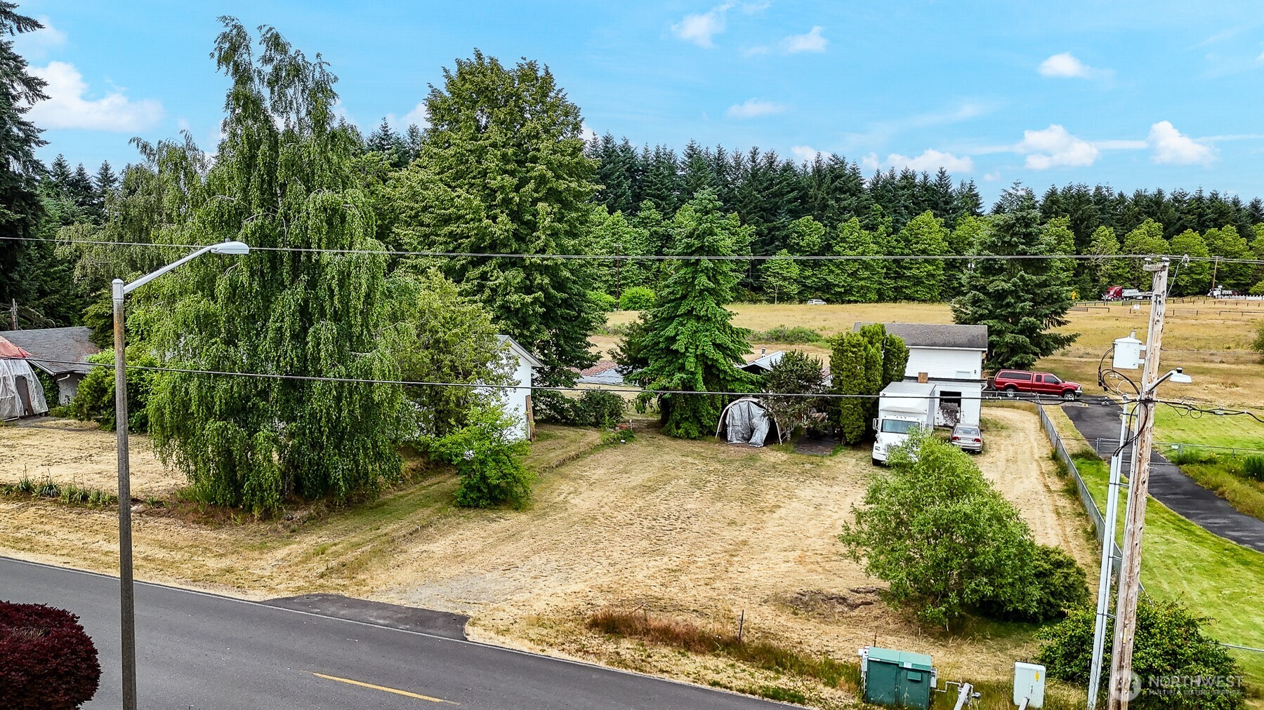 9139 Burnett Road Southeast Yelm, WA 98597 - Photo 2 of 40 a view of a yard with cars