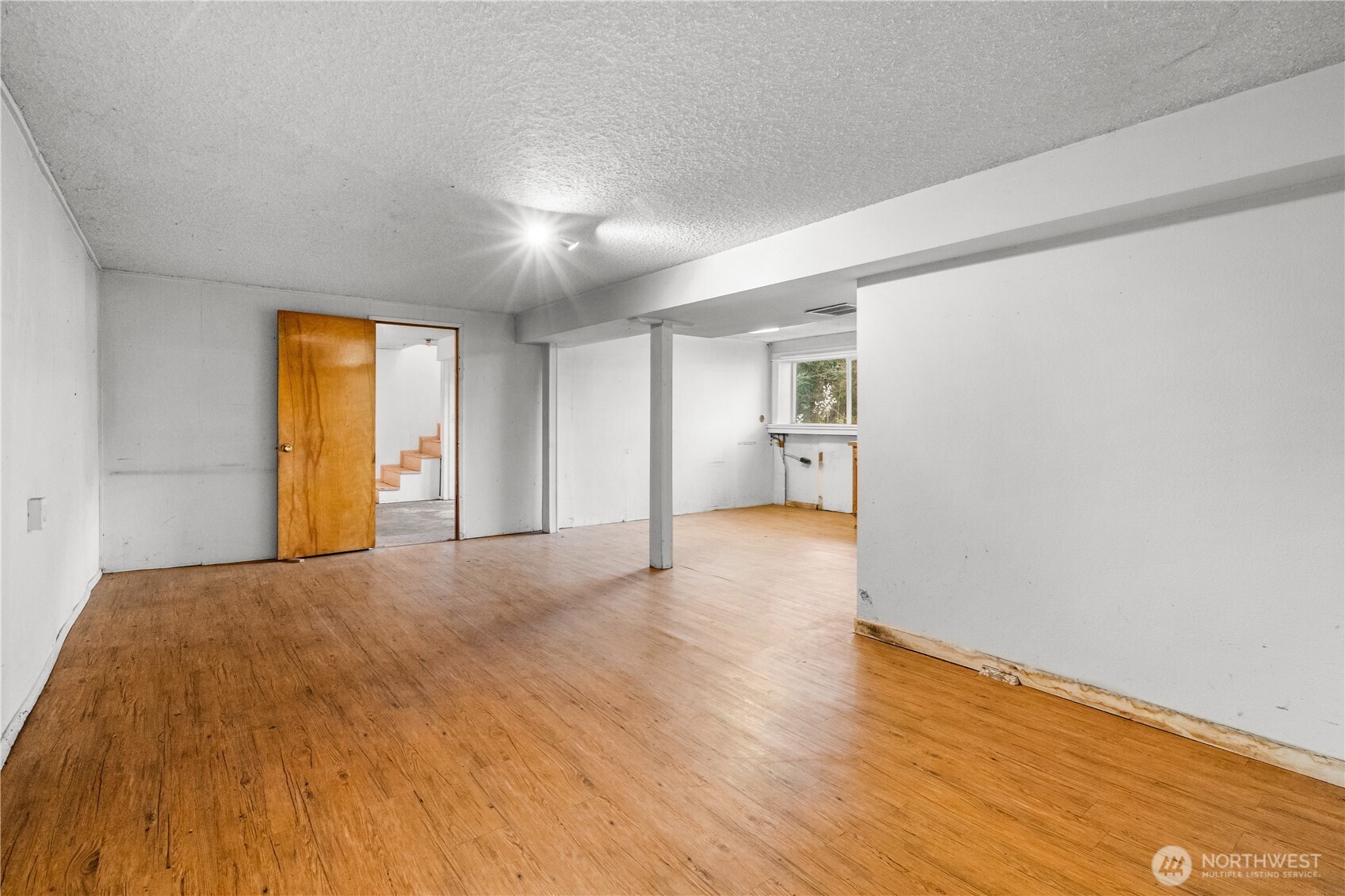 9139 Burnett Road Southeast Yelm, WA 98597 - Photo 24 of 40 a view of empty room with wooden floor and window