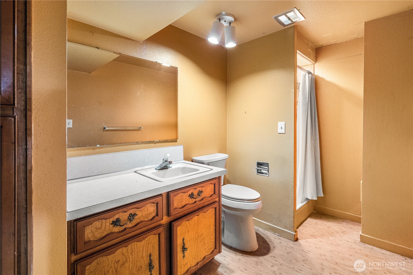 9139 Burnett Road Southeast Yelm, WA 98597 - Photo 27 of 40 a bathroom with a sink a toilet a mirror and shower