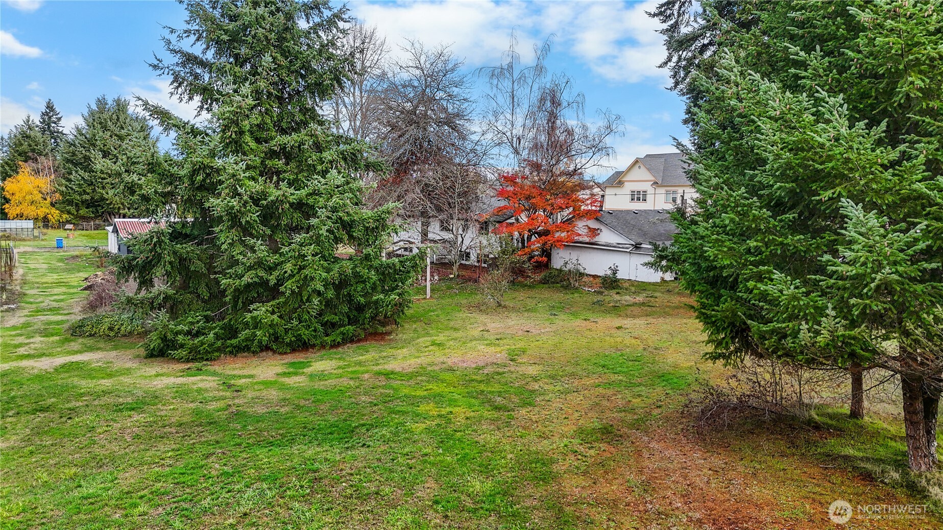 9139 Burnett Road Southeast Yelm, WA 98597 - Photo 39 of 40 a backyard of a house with table and chairs