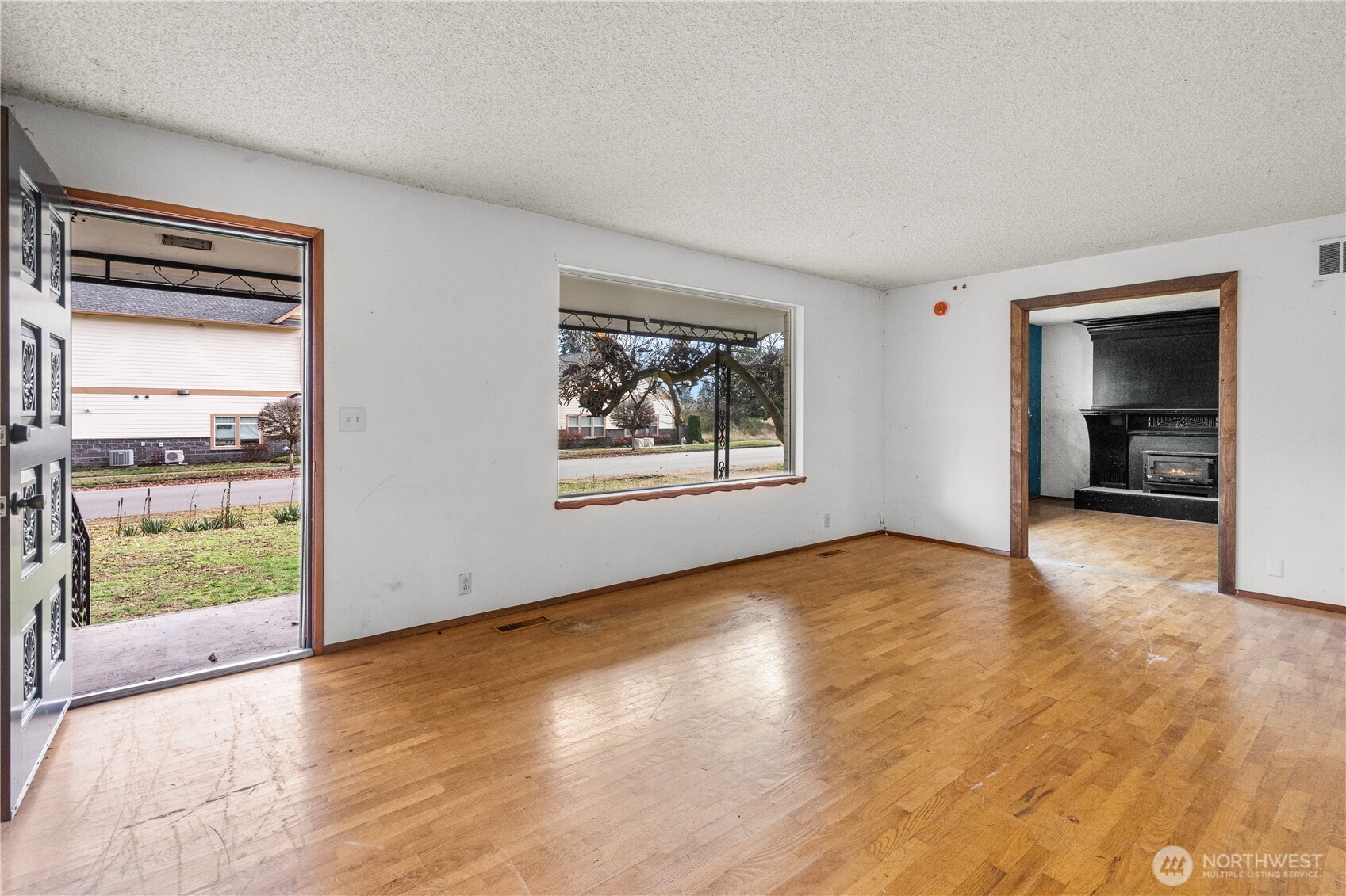9139 Burnett Road Southeast Yelm, WA 98597 - Photo 7 of 40 a view of an empty room with a window and wooden floor
