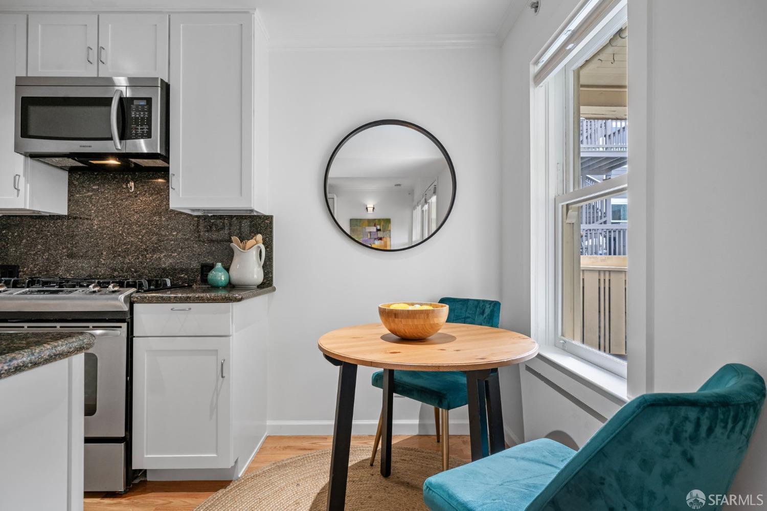333 Cherry Street, Unit B San Francisco, CA 94118 - Photo 13 of 34 a kitchen with stainless steel appliances granite countertop a dining table chairs and a microwave