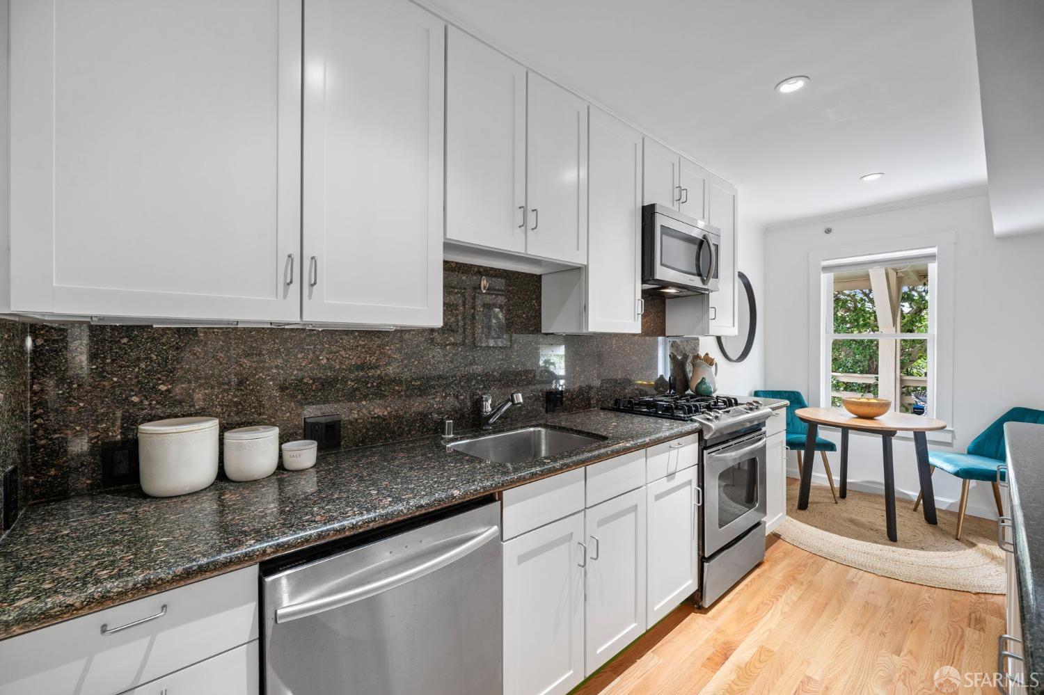 333 Cherry Street, Unit B San Francisco, CA 94118 - Photo 15 of 34 a kitchen with stainless steel appliances granite countertop a sink stove oven and white cabinets