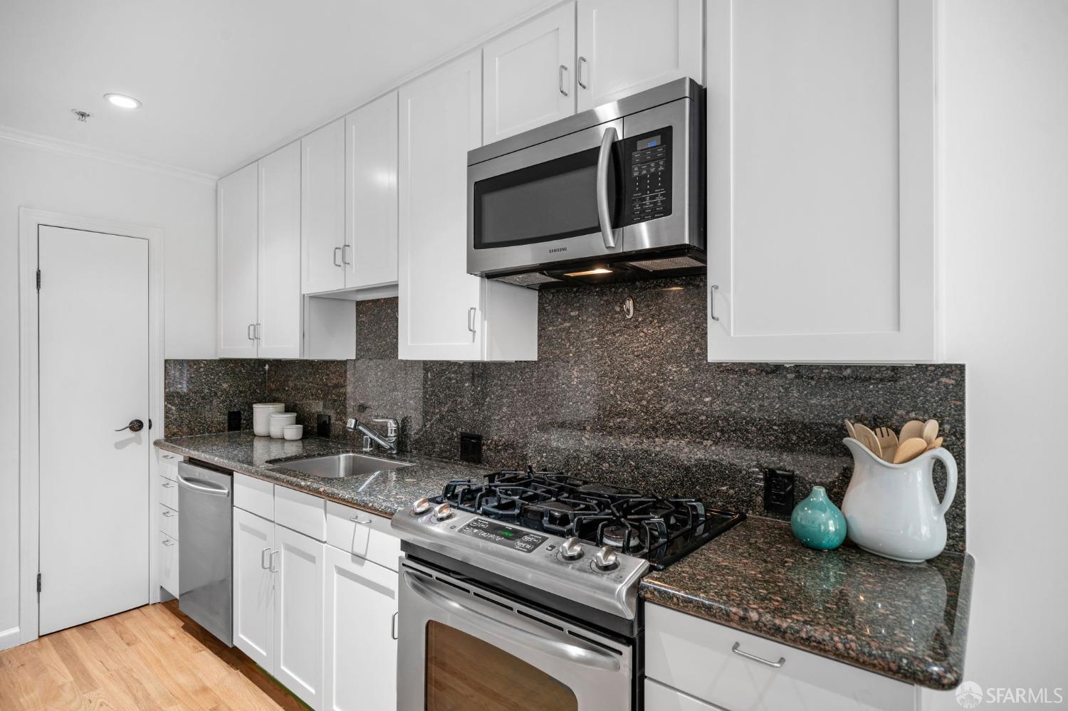 333 Cherry Street, Unit B San Francisco, CA 94118 - Photo 16 of 34 a kitchen with stainless steel appliances granite countertop a sink stove and microwave