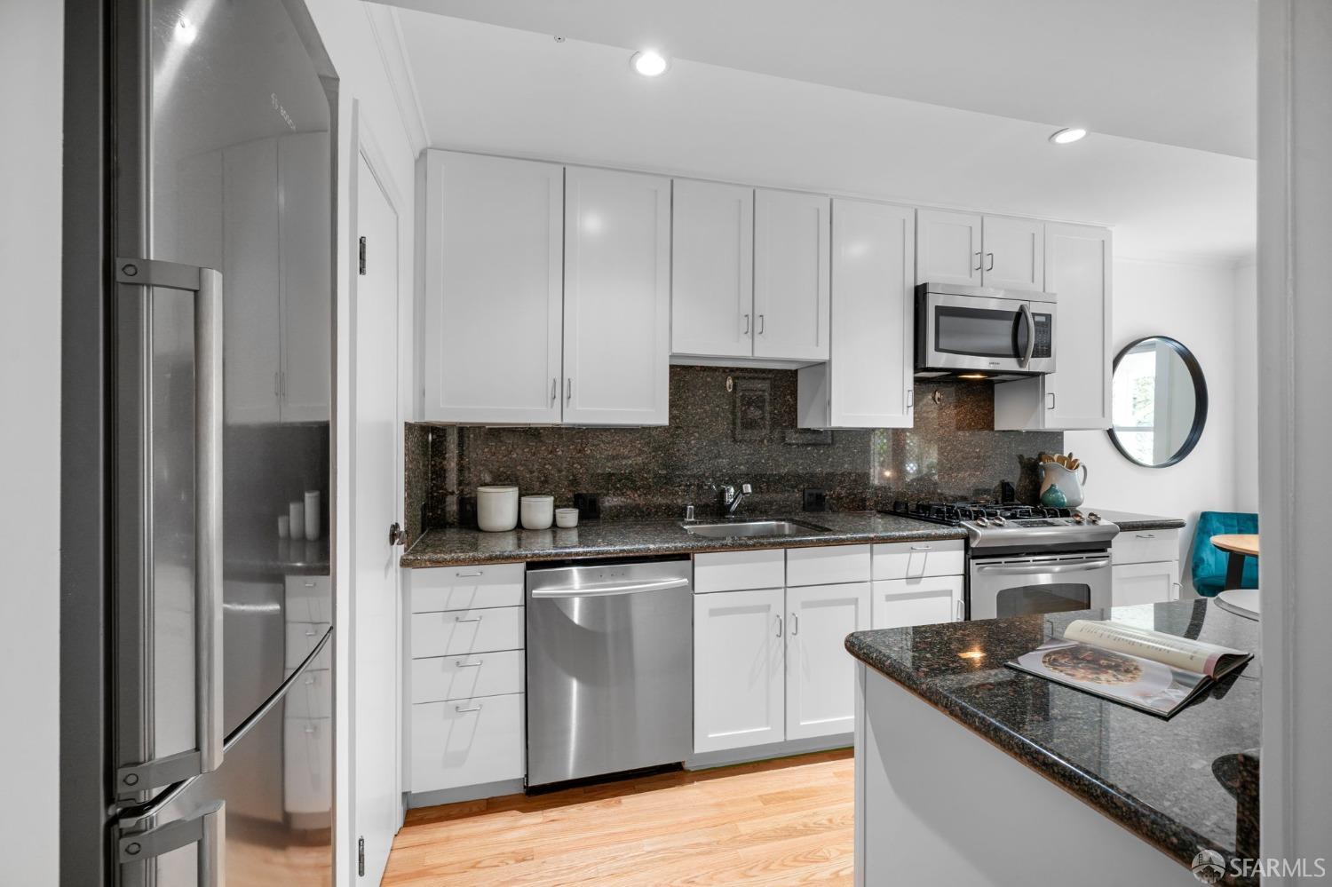 333 Cherry Street, Unit B San Francisco, CA 94118 - Photo 18 of 34 a kitchen with stainless steel appliances granite countertop a sink stove refrigerator and cabinets