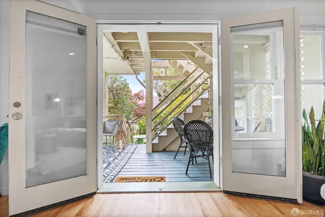 a view of an entryway with wooden floor and door