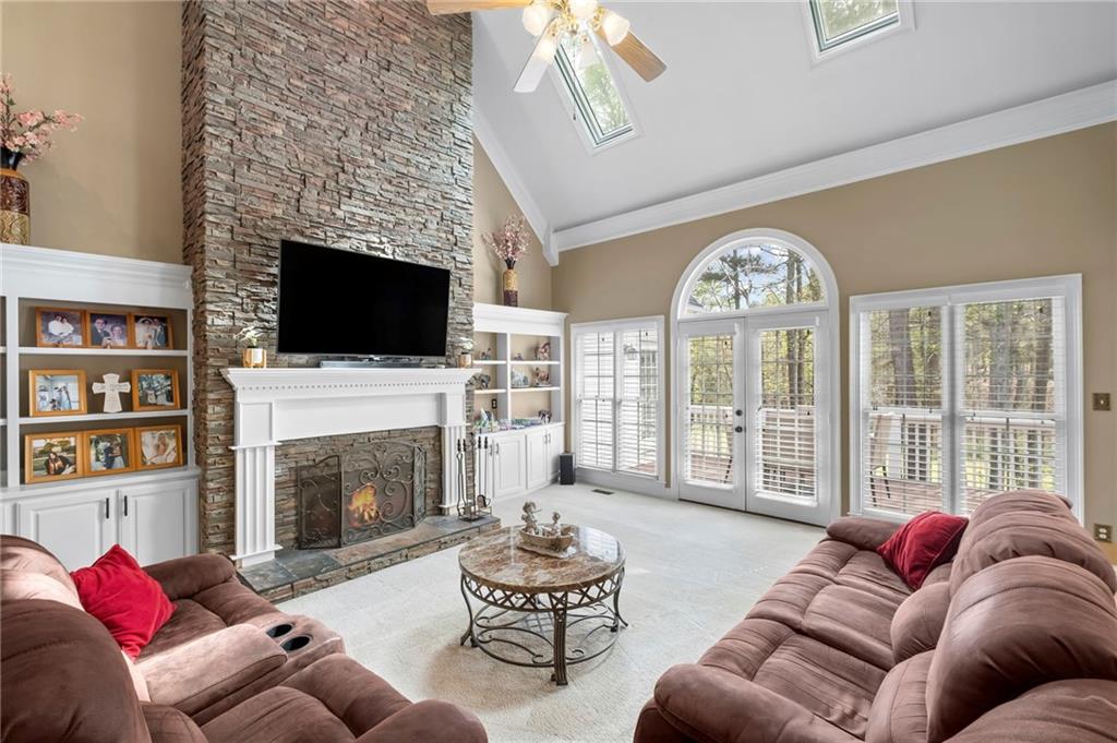 5870 Brookstone Walk Northwest Acworth, GA 30101 - Photo 2 of 79 a living room with furniture a fireplace and a flat screen tv