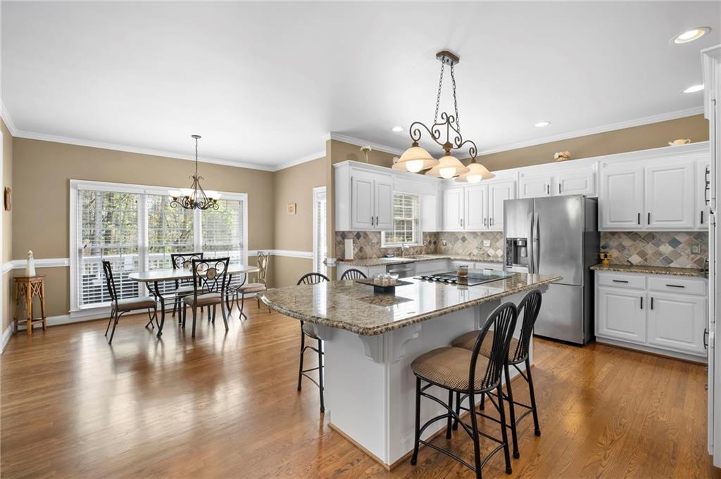 5870 Brookstone Walk Northwest Acworth, GA 30101 - Photo 3 of 79 a dining room with stainless steel appliances granite countertop a dining table chairs stove and kitchen view