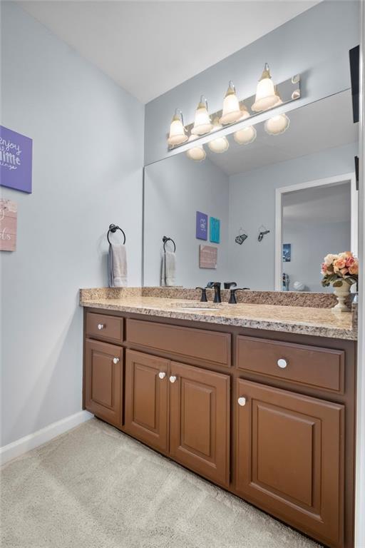5870 Brookstone Walk Northwest Acworth, GA 30101 - Photo 35 of 79 a bathroom with a granite countertop double vanity sink and mirror