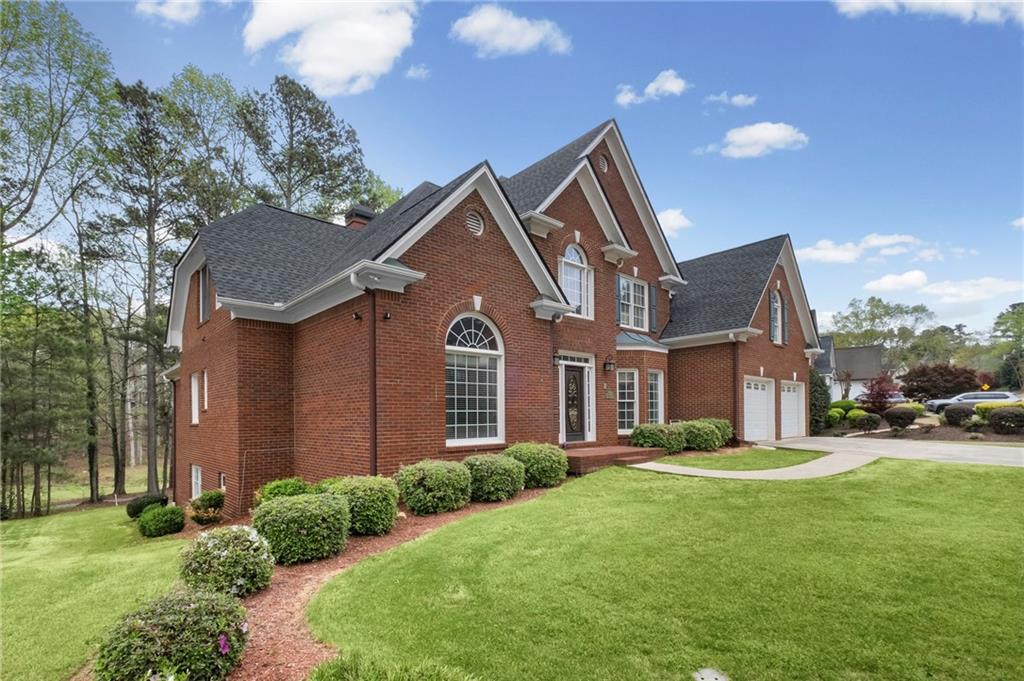 5870 Brookstone Walk Northwest Acworth, GA 30101 - Photo 52 of 79 a front view of a house with a yard and garage