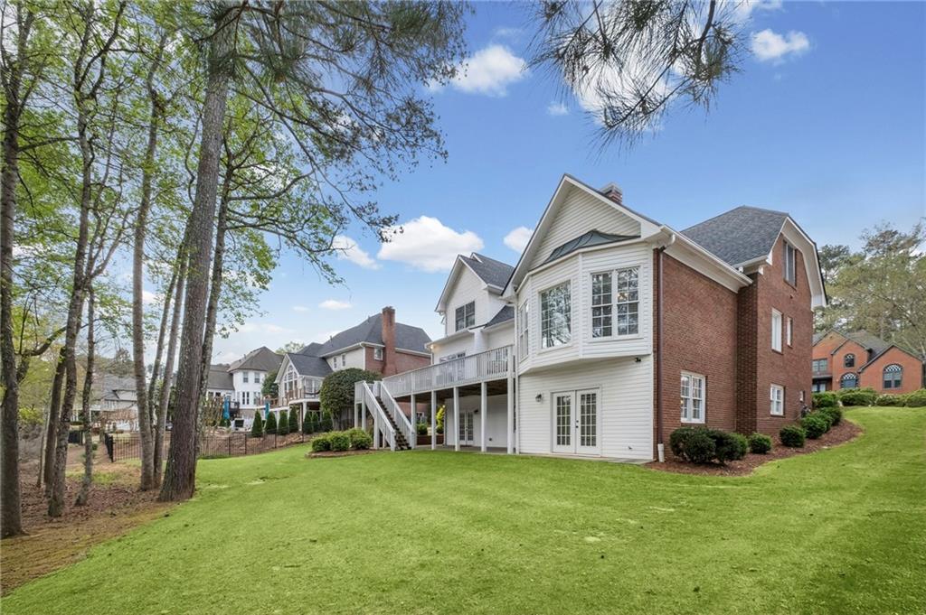 5870 Brookstone Walk Northwest Acworth, GA 30101 - Photo 60 of 79 a view of a house with a big yard and large trees