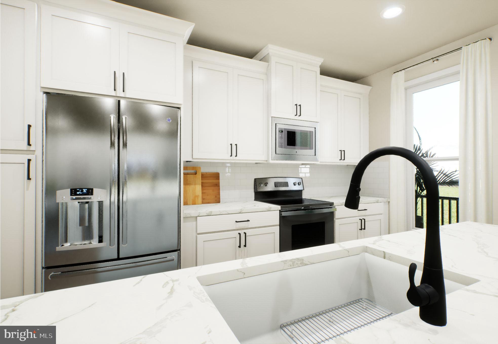 21797 Croxley Terrace Broadlands, VA 20148 - Photo 1 of 17 a kitchen with a refrigerator and white cabinets