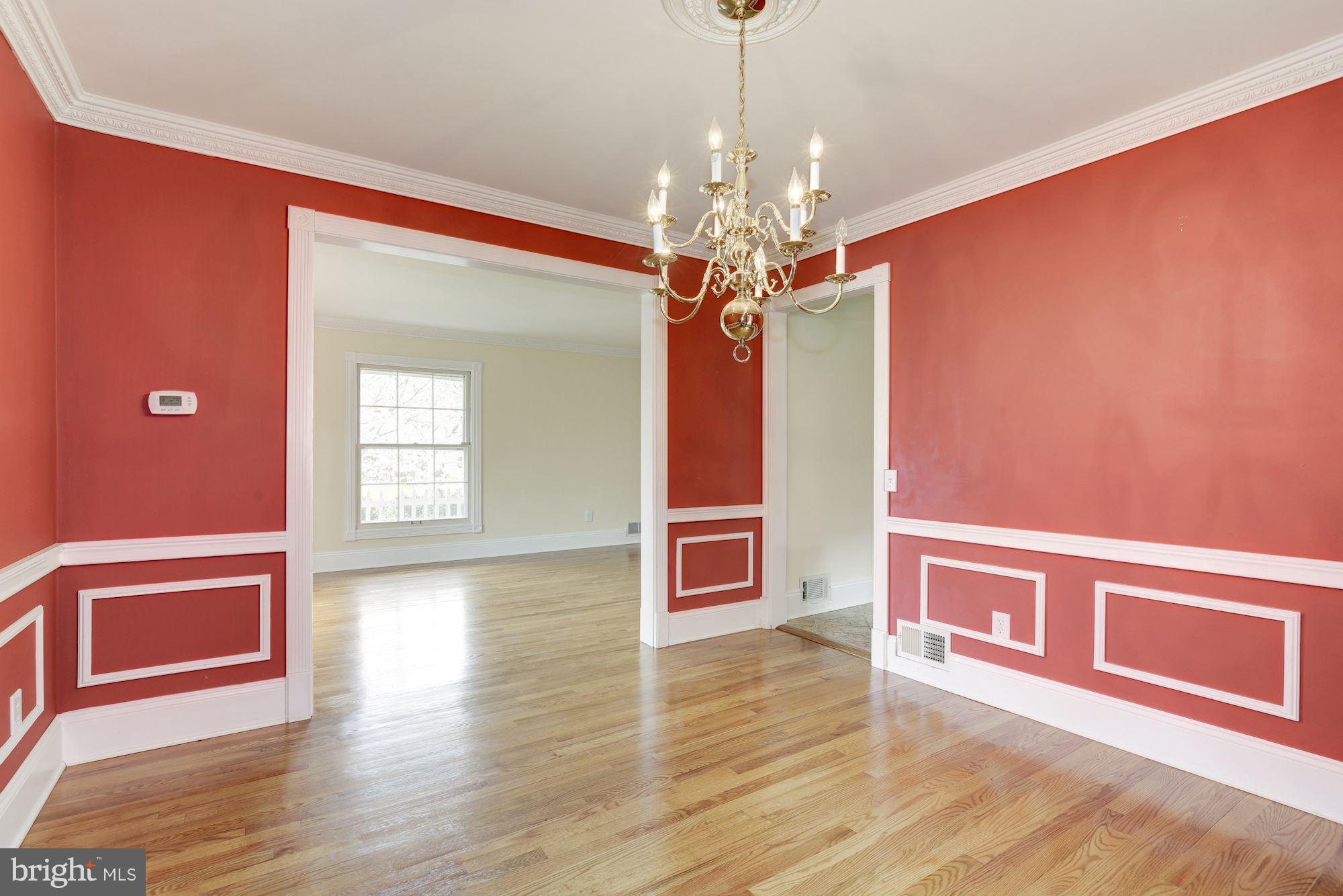 8524 Fox Run Potomac, MD 20854 - Photo 11 of 30 a view of a livingroom with wooden floor a ceiling fan and windows
