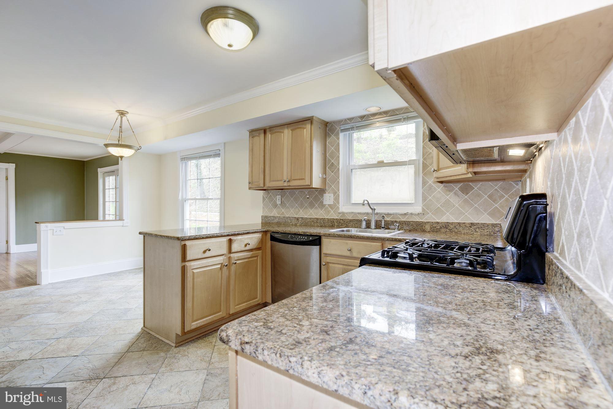 8524 Fox Run Potomac, MD 20854 - Photo 12 of 30 a kitchen with a sink a stove a microwave and cabinets