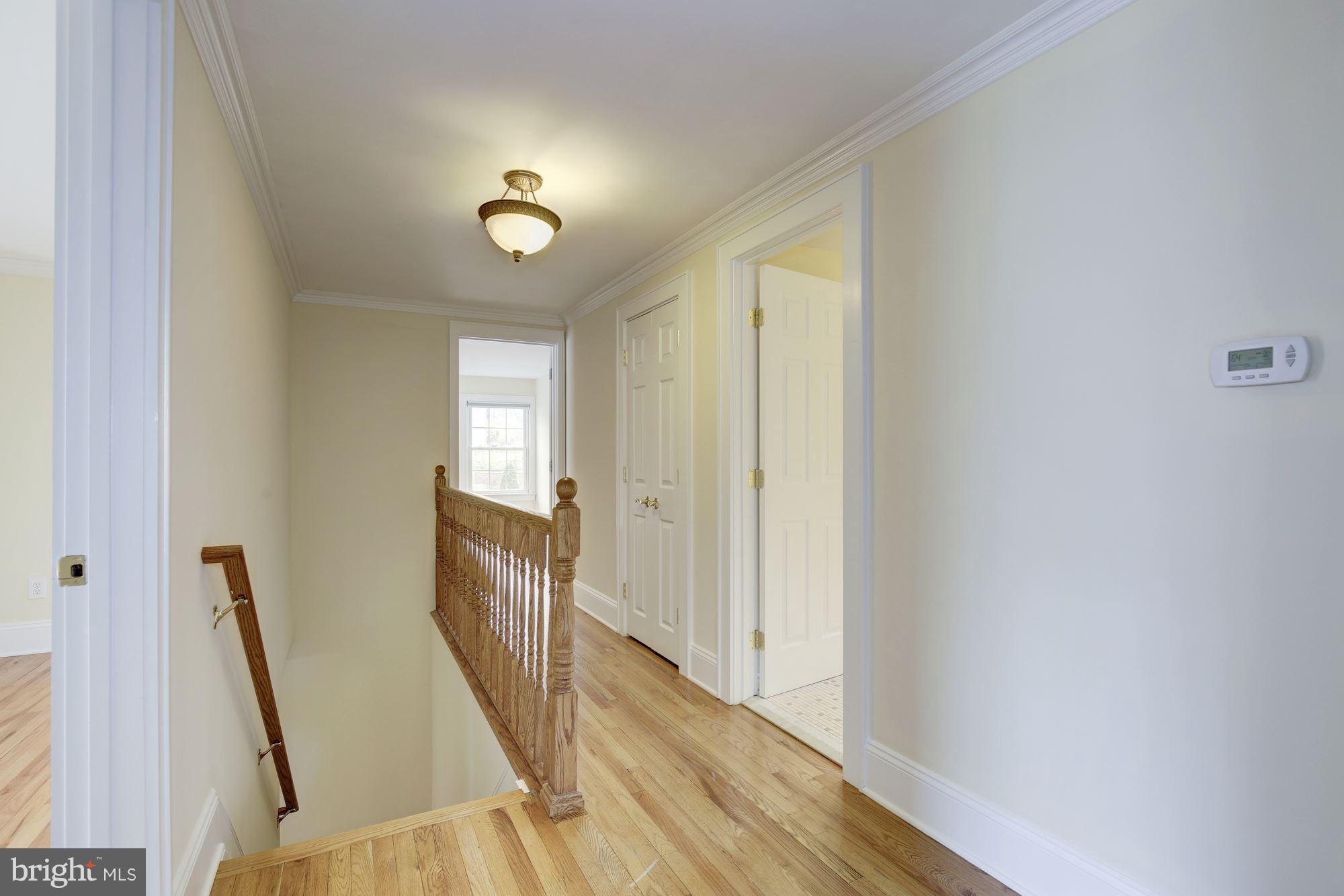 8524 Fox Run Potomac, MD 20854 - Photo 19 of 30 a view of a hallway with wooden floor and staircase