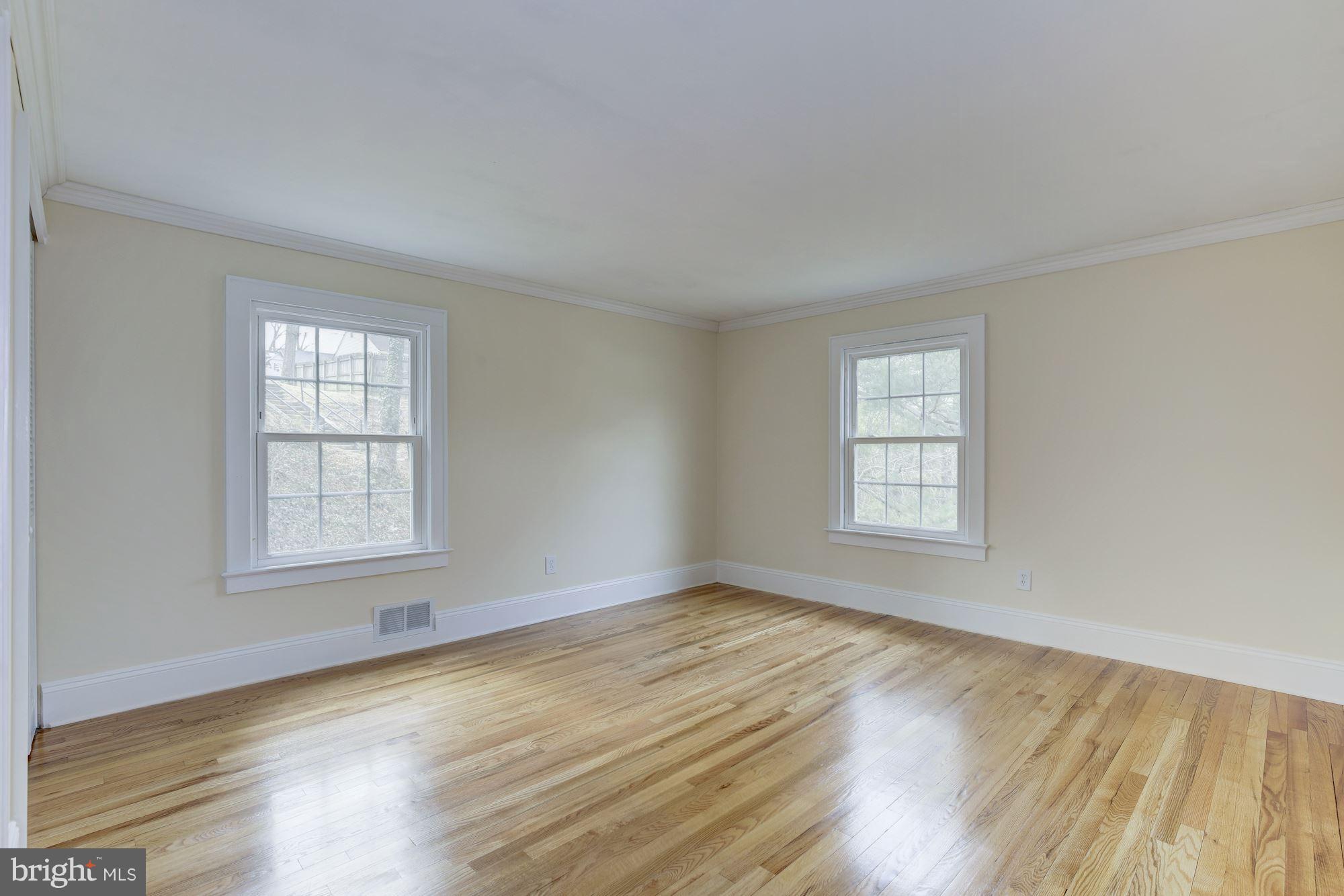 8524 Fox Run Potomac, MD 20854 - Photo 21 of 30 an empty room with wooden floor and windows