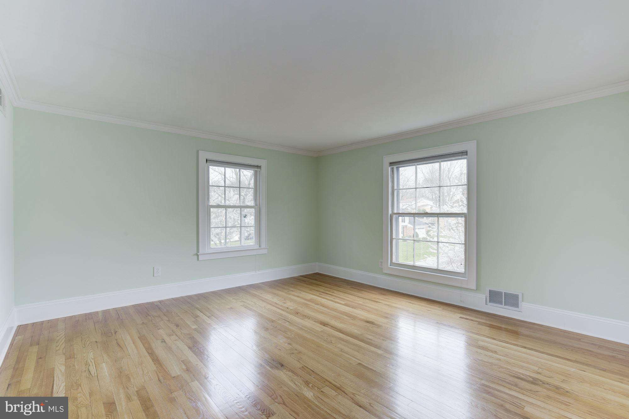 8524 Fox Run Potomac, MD 20854 - Photo 22 of 30 an empty room with wooden floor and windows