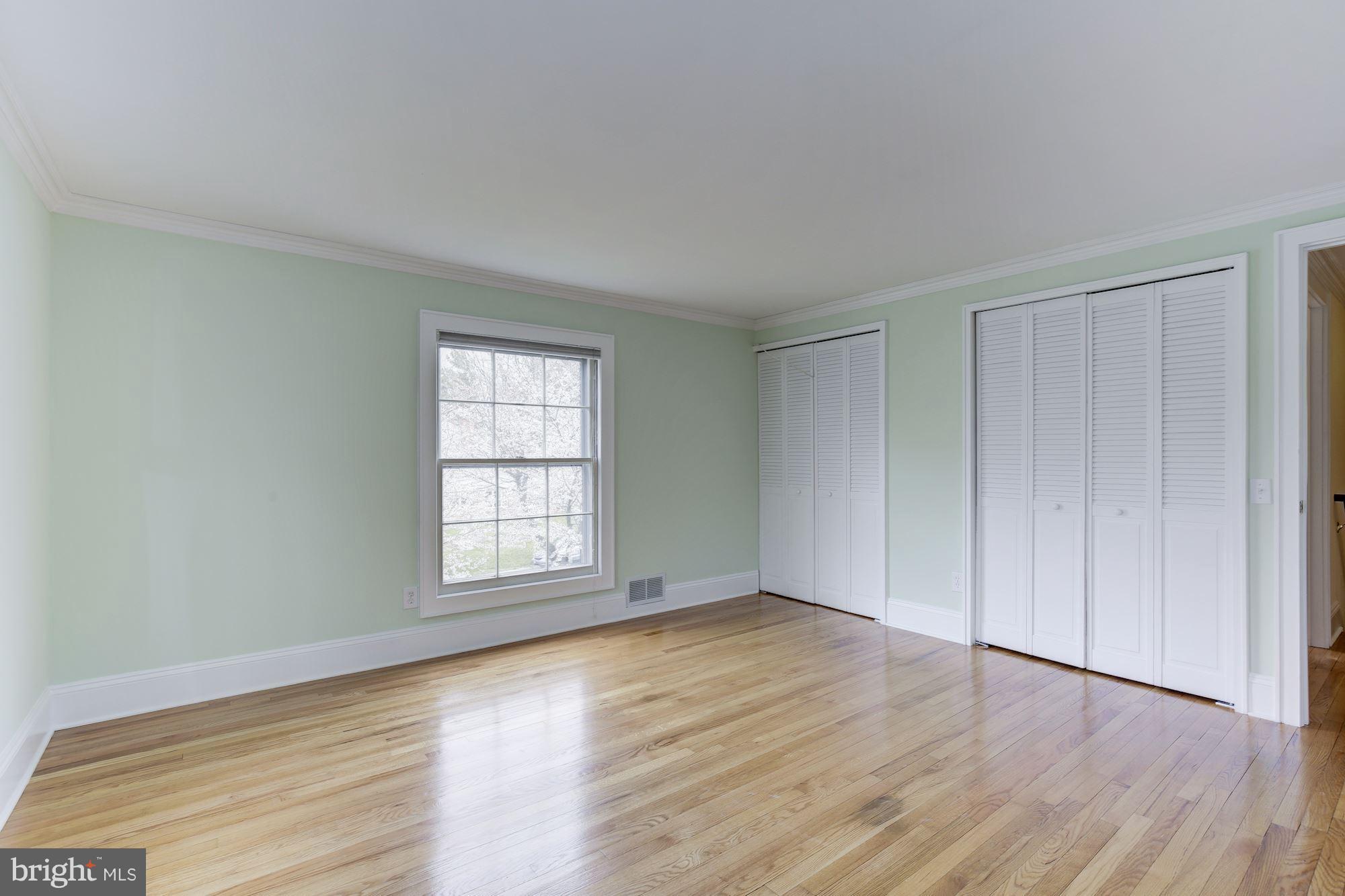 8524 Fox Run Potomac, MD 20854 - Photo 23 of 30 a view of an empty room with wooden floor and window