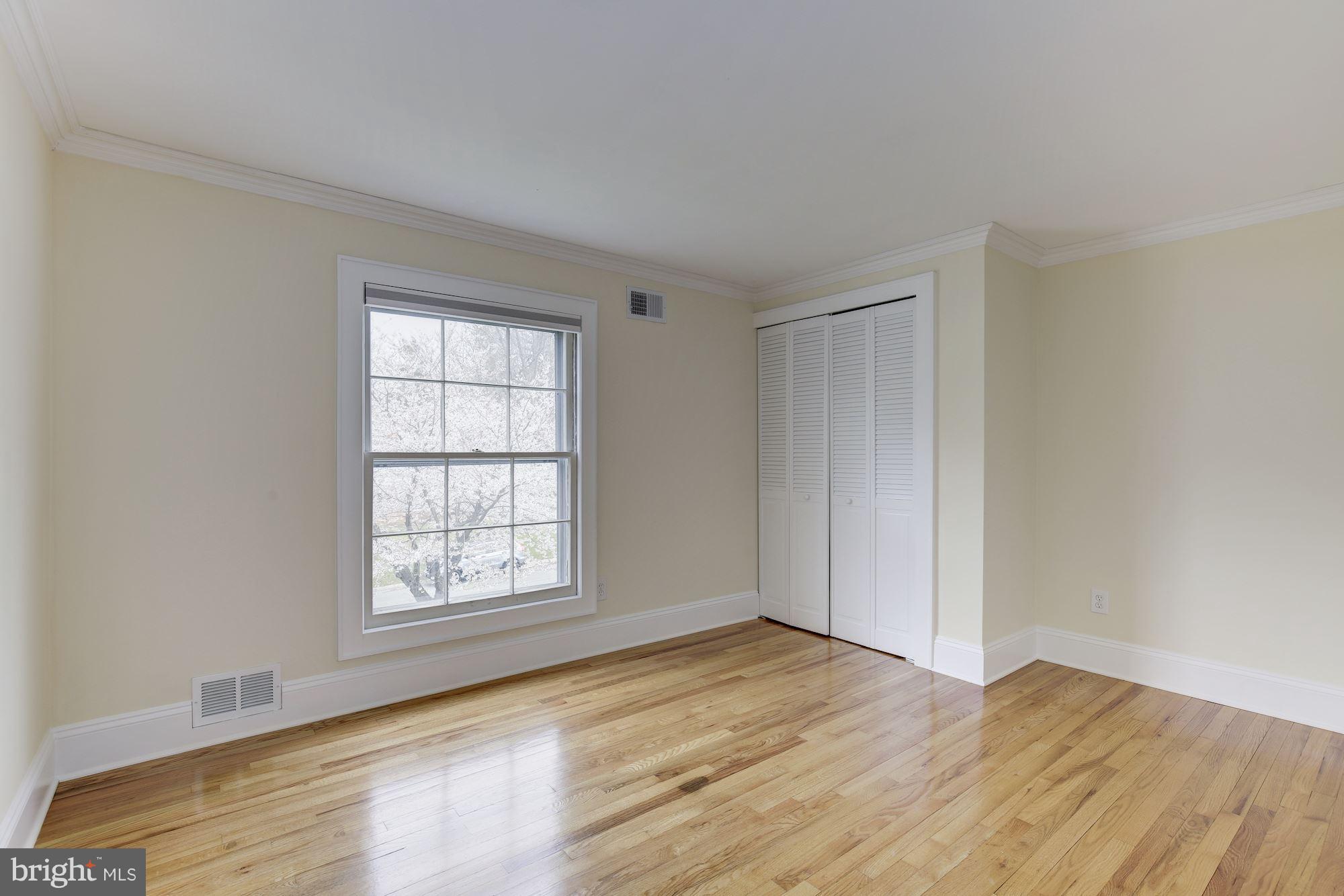 8524 Fox Run Potomac, MD 20854 - Photo 24 of 30 an empty room with wooden floor and windows
