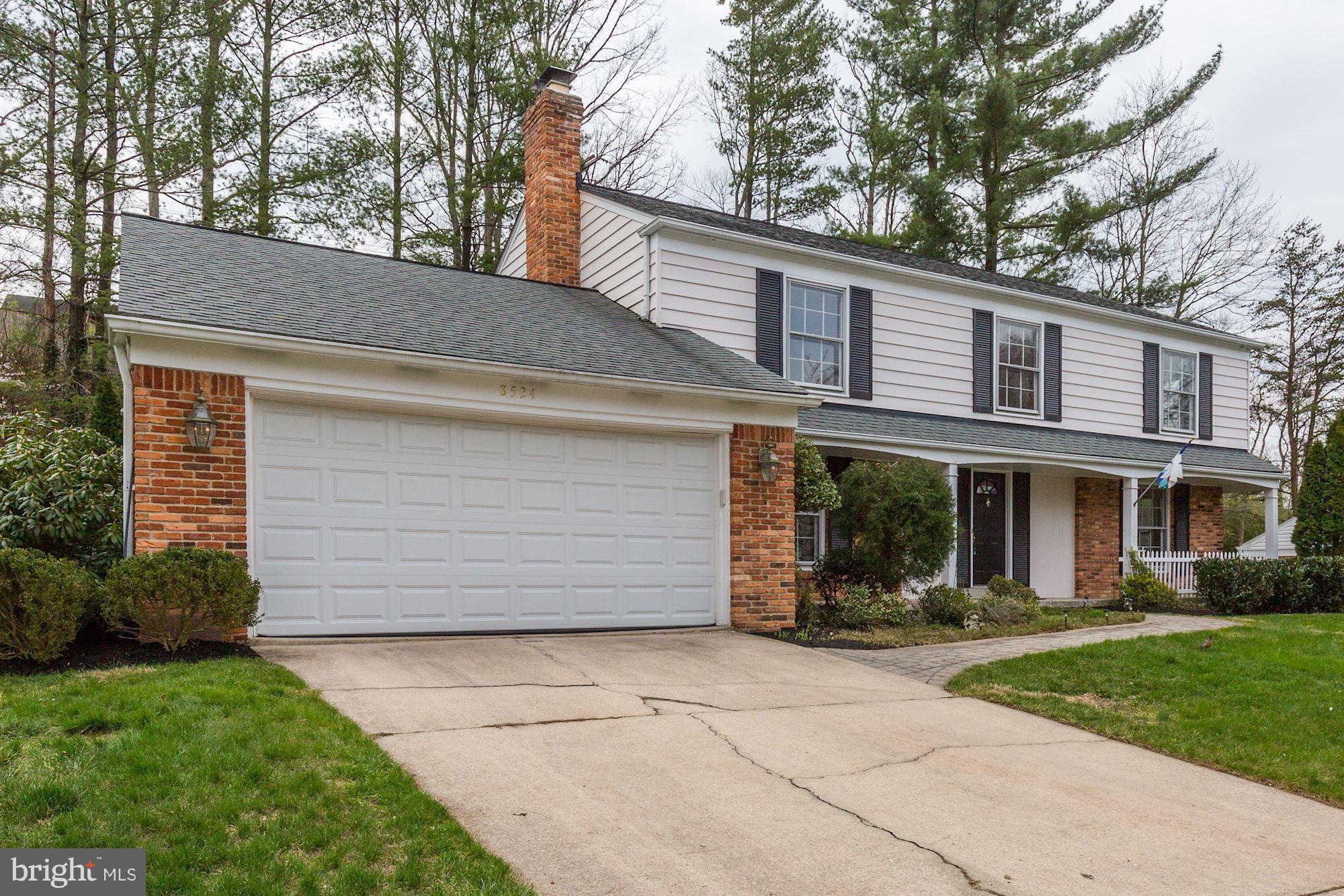 8524 Fox Run Potomac, MD 20854 - Photo 4 of 30 a view of a white house with large windows and a small yard