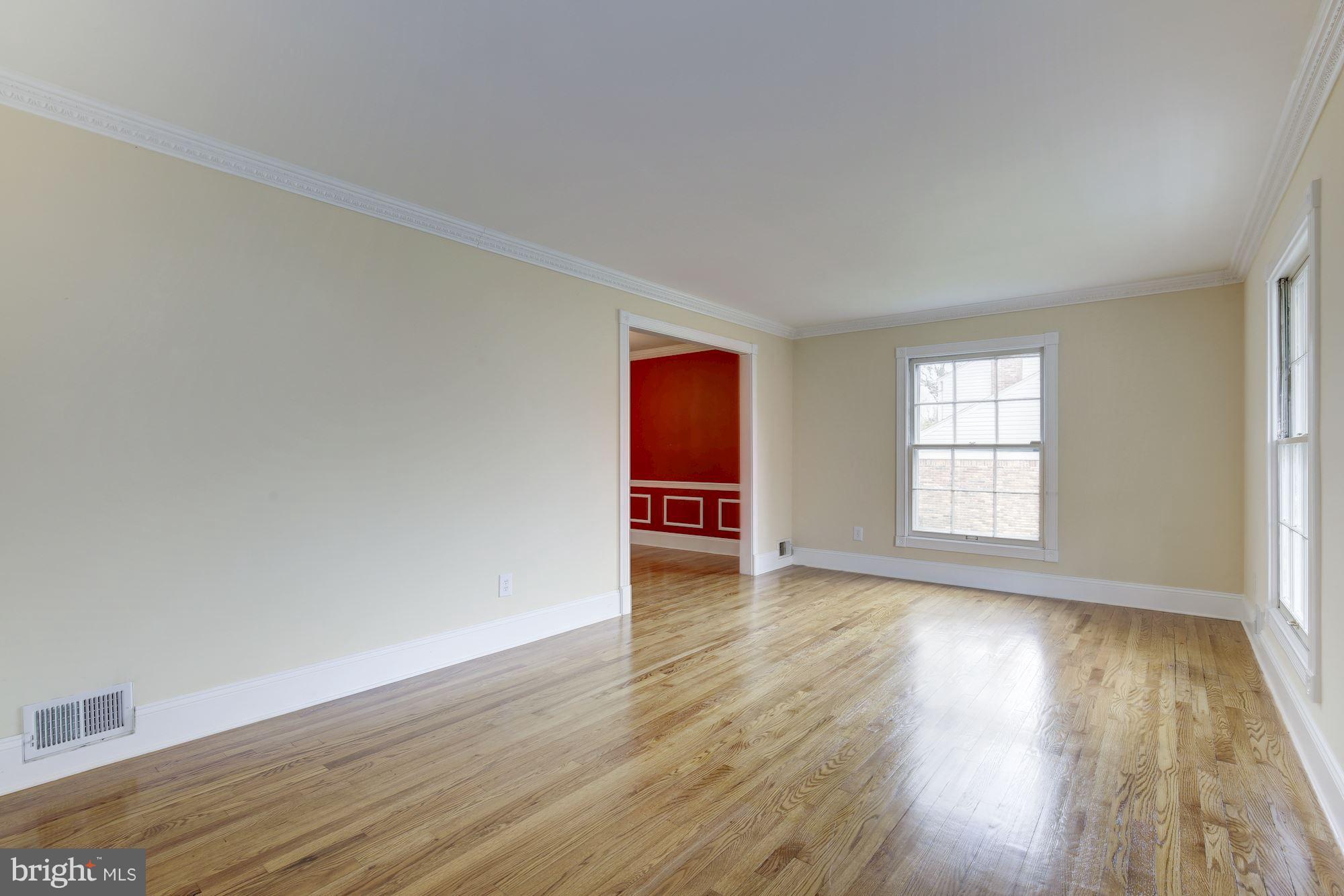 8524 Fox Run Potomac, MD 20854 - Photo 9 of 30 an empty room with wooden floor and windows