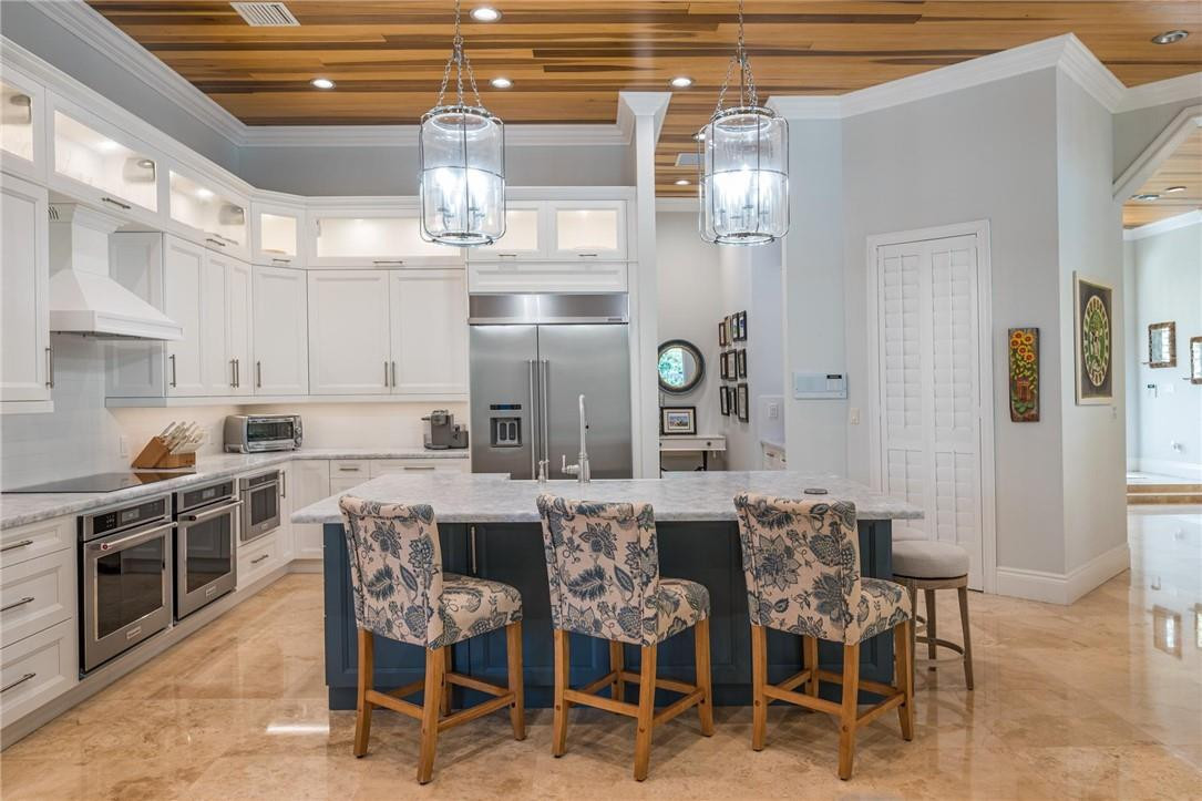 16901 Southwest 63rd Manor Southwest Ranches, FL 33331 - Photo 16 of 53 a kitchen with lots of counter top space and dining table