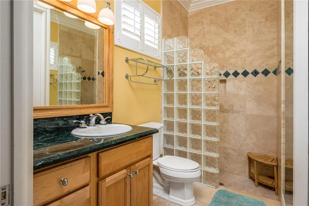 16901 Southwest 63rd Manor Southwest Ranches, FL 33331 - Photo 35 of 53 a bathroom with a granite countertop sink toilet and shower