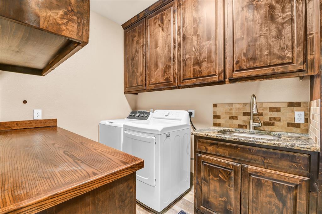 854 County Road 3330 Bridgeport, TX 76426 - Photo 17 of 40 The utility room is a dream! Ample work space with plenty of storage for your soaps and accessories. Granite countertop with stainless sink and tile backsplash.