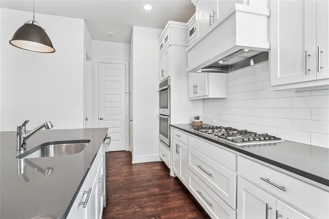 a spacious bedroom with a bed and a chandelier