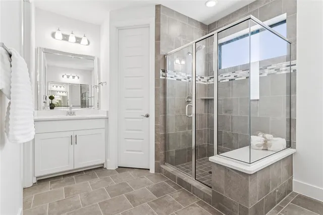a spacious bathroom with a shower sink and mirror