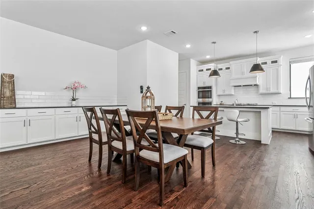 a kitchen with stainless steel appliances granite countertop a sink refrigerator and cabinets
