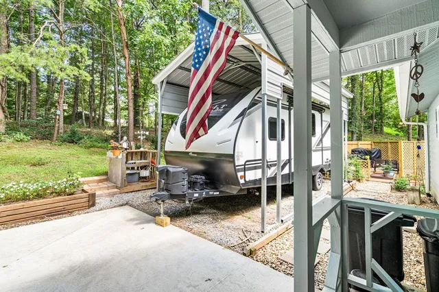 a view of a lush green forest with trees and some houses