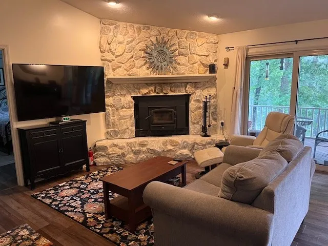 a living room with furniture a flat screen tv and a fireplace