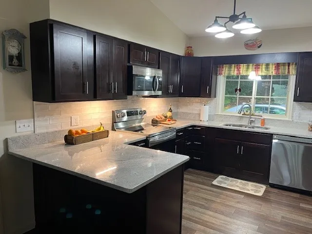 a living room with furniture a fireplace and a large window