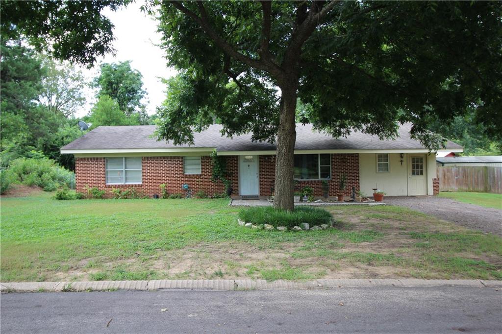 305 Arthur Street Lindale, TX 75771 - Photo 1 of 1 a front view of a house with a garden