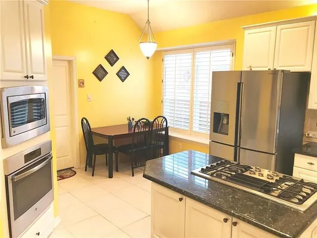 a kitchen with a table and chairs