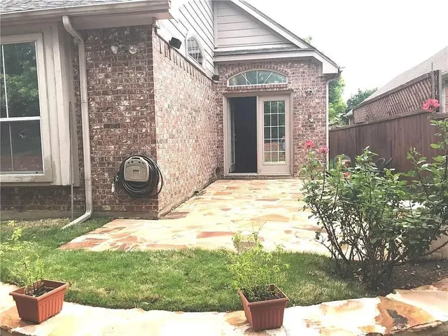a backyard of a house with yard and outdoor seating