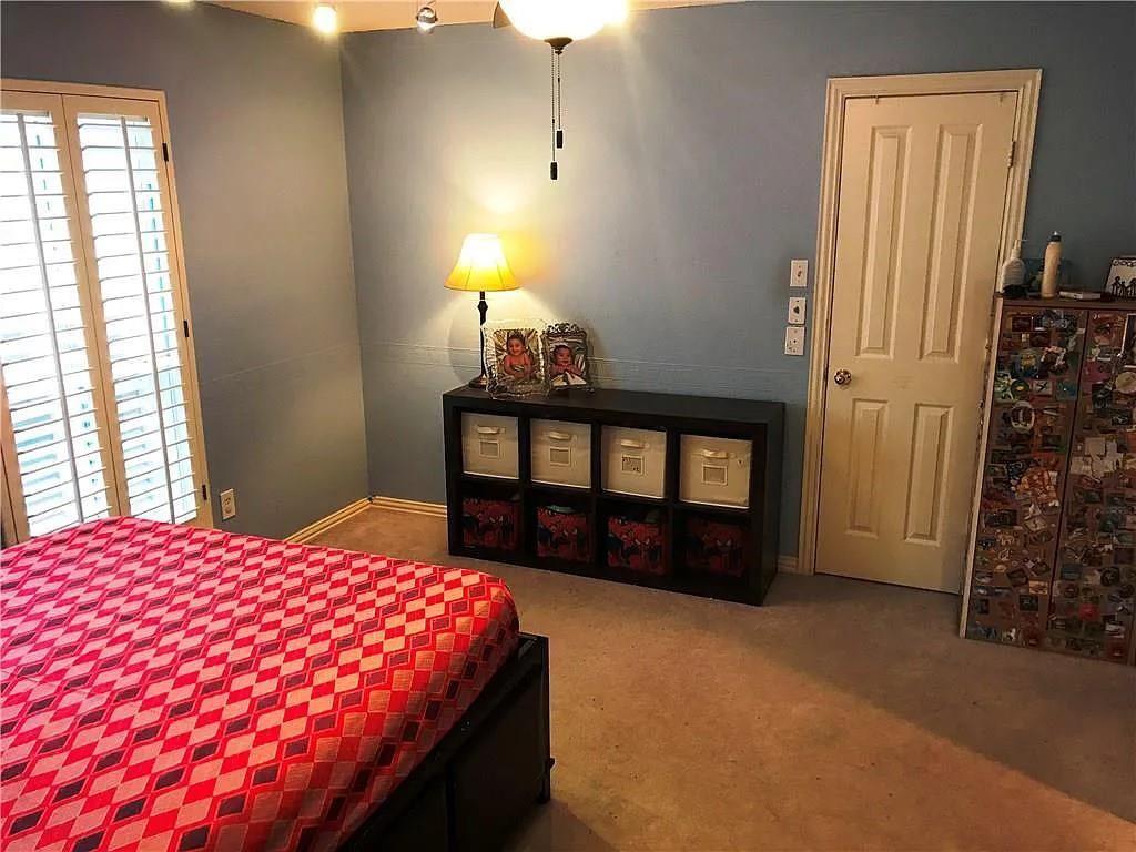 9400 Western Trail Irving, TX 75063 - Photo 7 of 24 a bed sitting in a bedroom next to a window