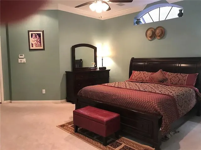 a bedroom with a bed and a chandelier