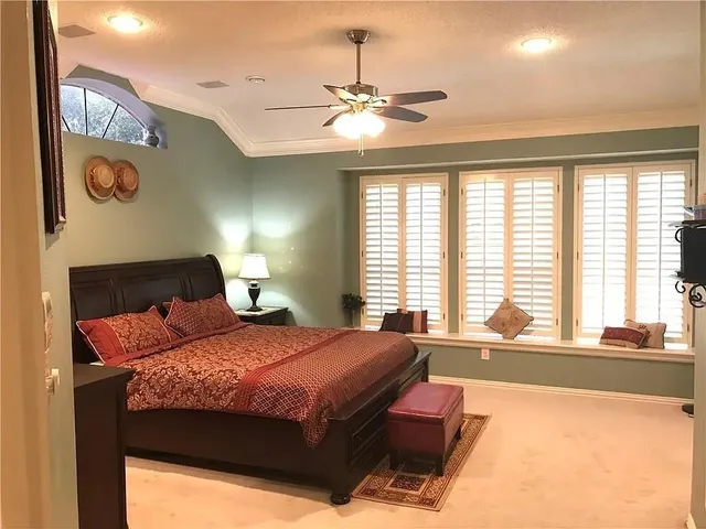 a bedroom with a large bed and a large window