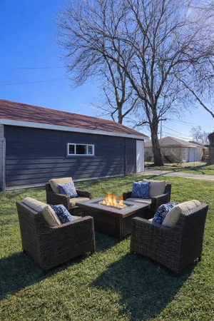 a view of a couches in a patio with a yard