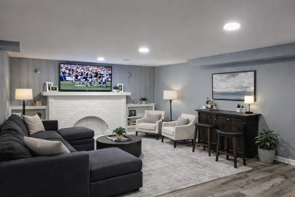 a living room with furniture a fireplace and a flat screen tv