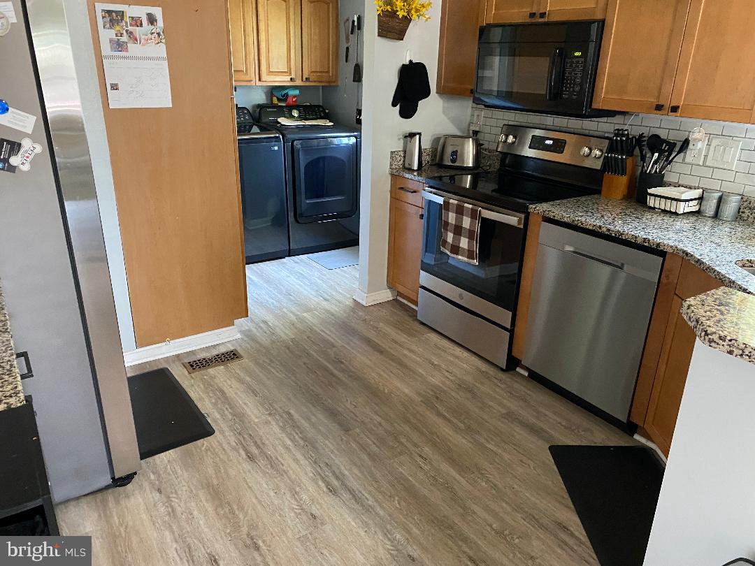 14 Thomas Lane Sparrows Point, MD 21219 - Photo 20 of 26 a kitchen with stainless steel appliances granite countertop a refrigerator a stove top oven a sink and dishwasher