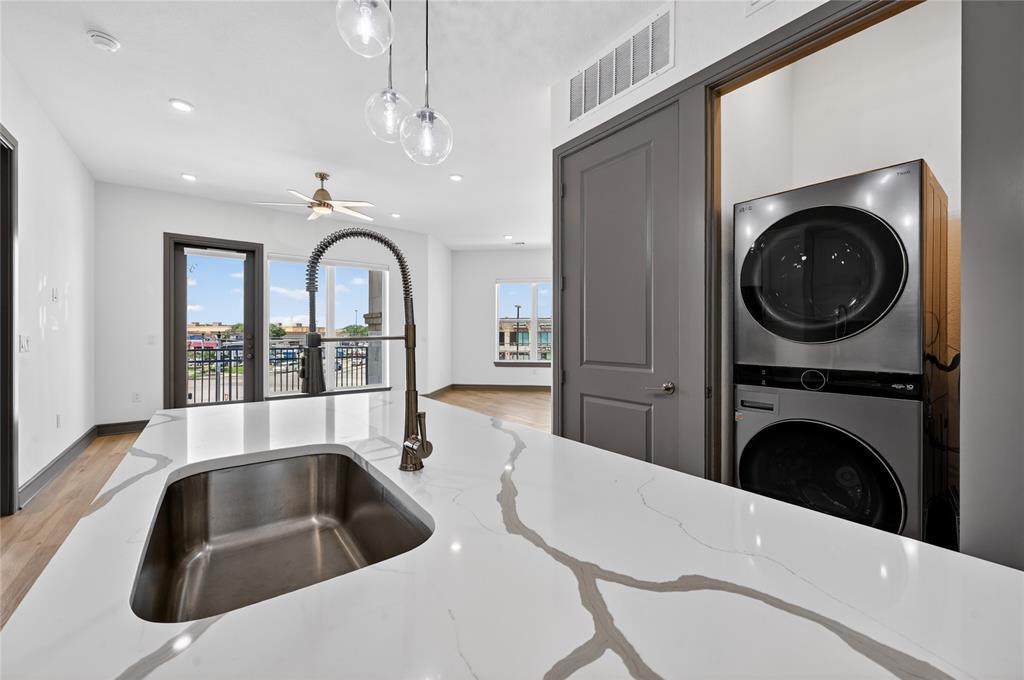 2700 Old Denton Road, Unit 2259 Carrollton, TX 75007 - Photo 13 of 39 a kitchen with a sink a washer and dryer