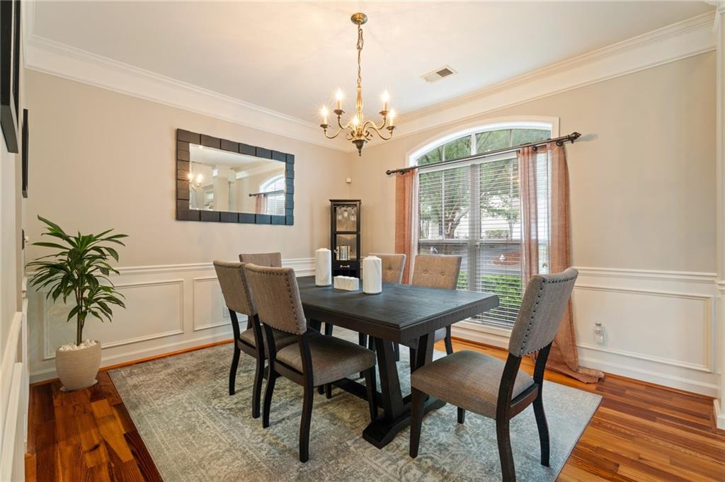 878 Scales Road Suwanee, GA 30024 - Photo 4 of 17 a view of a dining room with furniture window and wooden floor