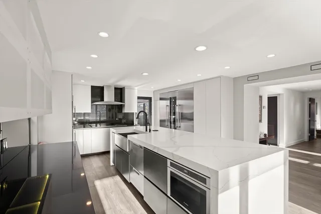 a large kitchen with stainless steel appliances granite countertop a stove and a sink