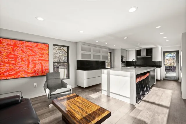 a kitchen with stainless steel appliances kitchen island granite countertop a refrigerator and a stove top oven