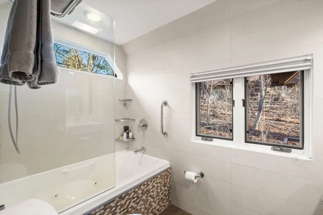 a bathroom with a bathtub and a shower