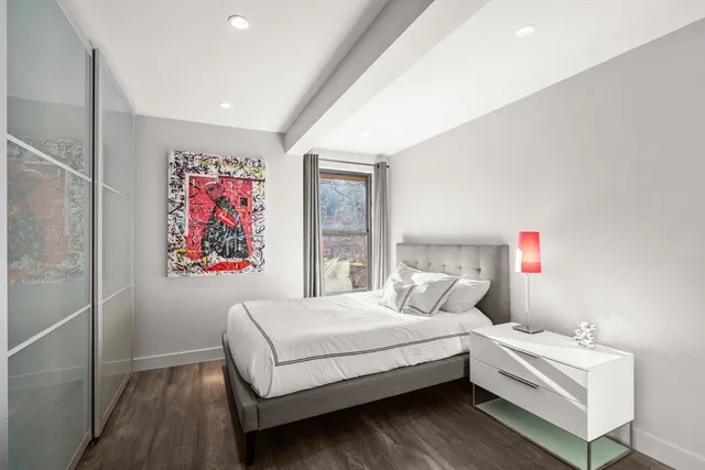 a bedroom with a bed and a window